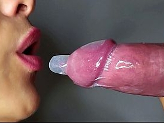 Close-up of a wet blowjob with a condom. Beautiful lips warm my cock